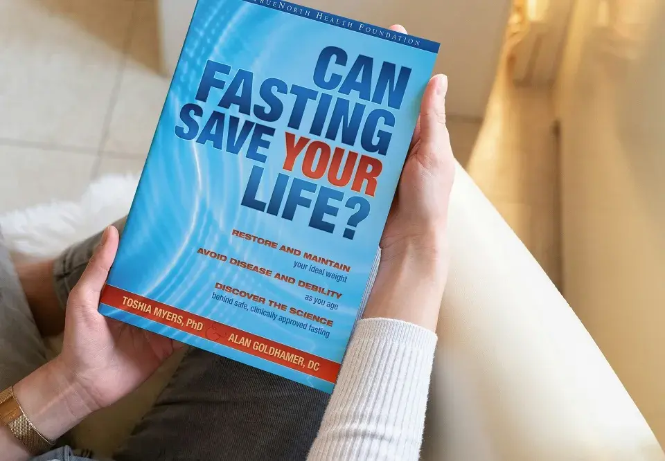 Woman holding fasting book